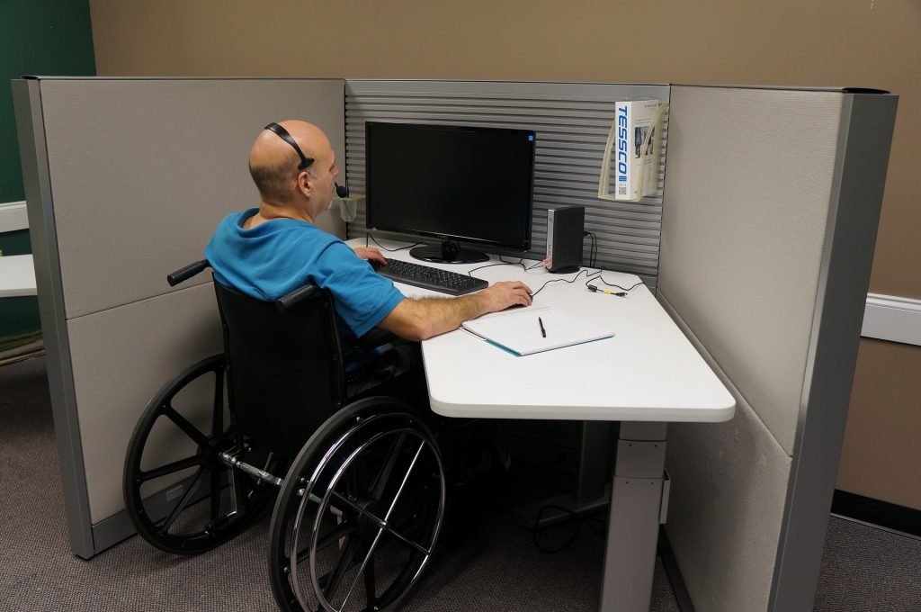 Worker in wheelchair at desk