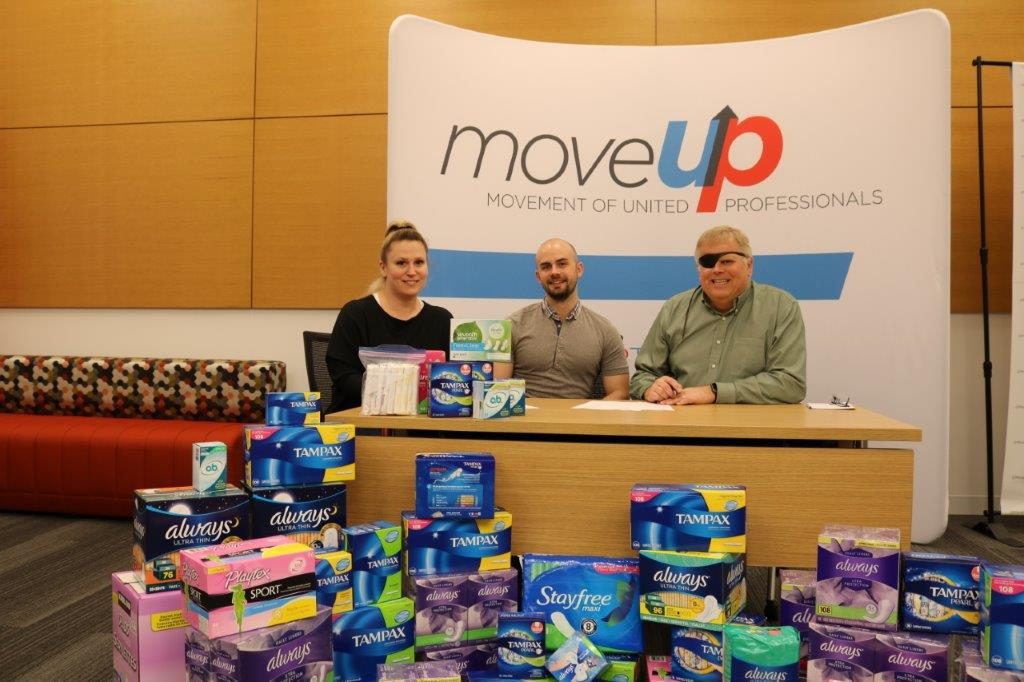 Three people posing with period hygienic products