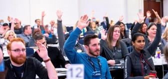 Convention participants raising hands