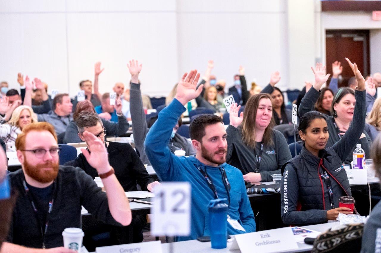 Convention participants raising hands