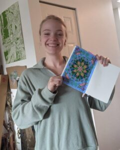 Woman holding up picture of flower