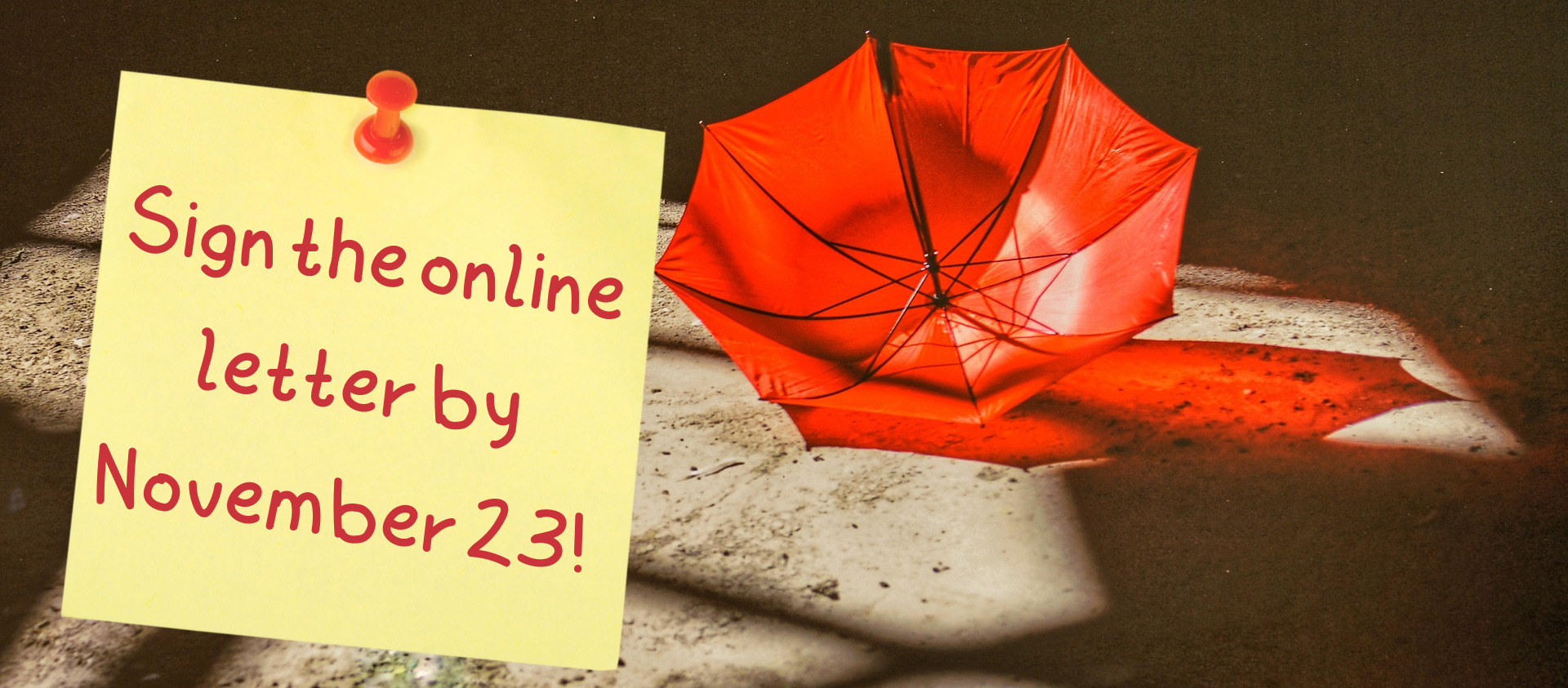 Open red umbrella on sand, with sticky note saying "Sign the online letter by November 23!"