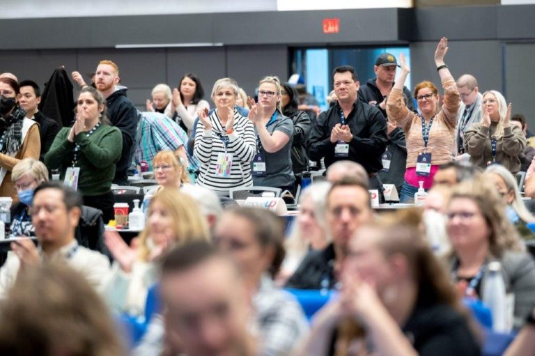 MoveUP delegation at BCFED Convention standing and applausing