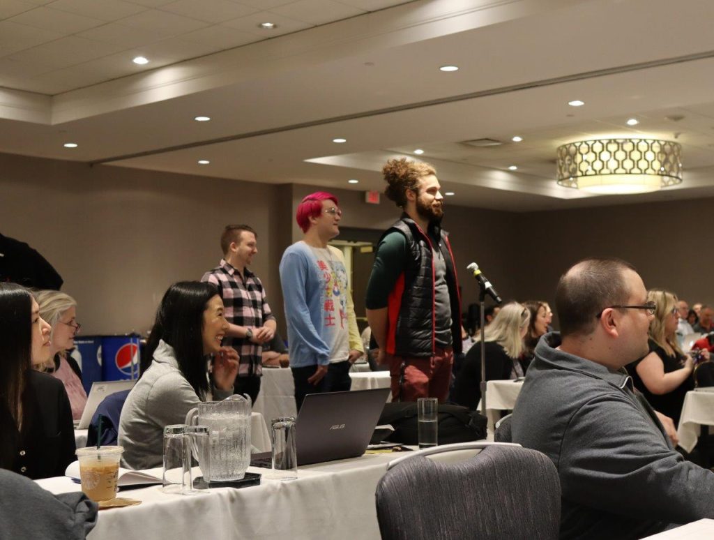 Executive councillors lining up to speak at a microphone