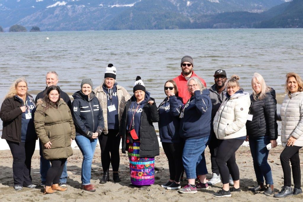 Course participants at Job Steward Seminar pose for a photo on the beach