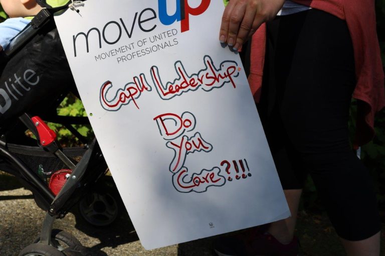 Picket sign with MoveUP logo and the text: "CapU Leadership Do You Care?!!!"