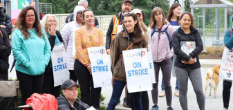 MoveUP members wearing picket signs at the Capilano University picket line
