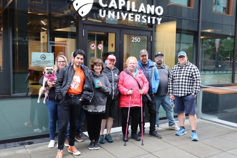 MoveUP members standing outside CapU Lonsdale building