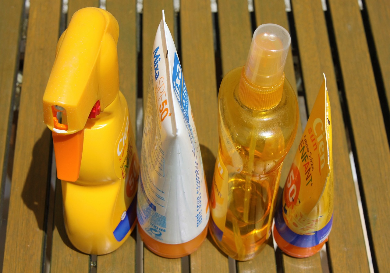 various bottles of spray and lotion sunscreens
