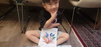 child showing off drawing