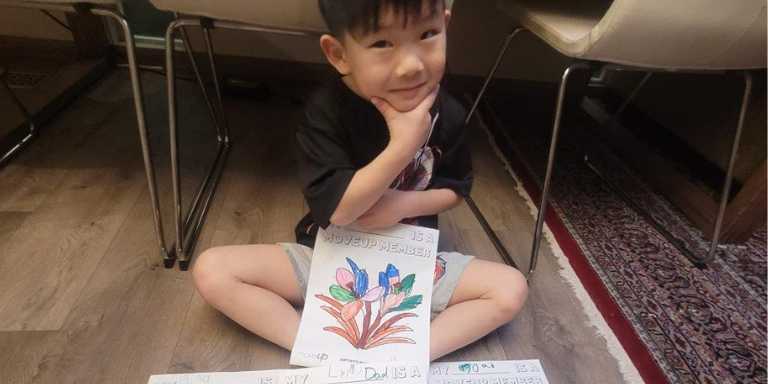 child showing off drawing