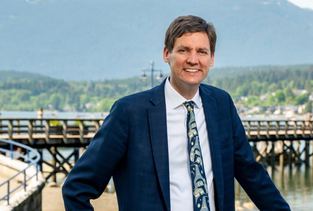 Premier David Eby with Vancouver in the backdrop