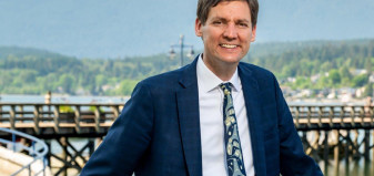 Premier David Eby with Vancouver in the backdrop