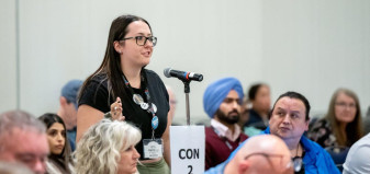 Woman speaking at a Con mic at Convention