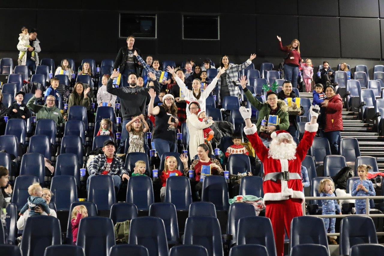 Santa at movie theatre with MoveUP members