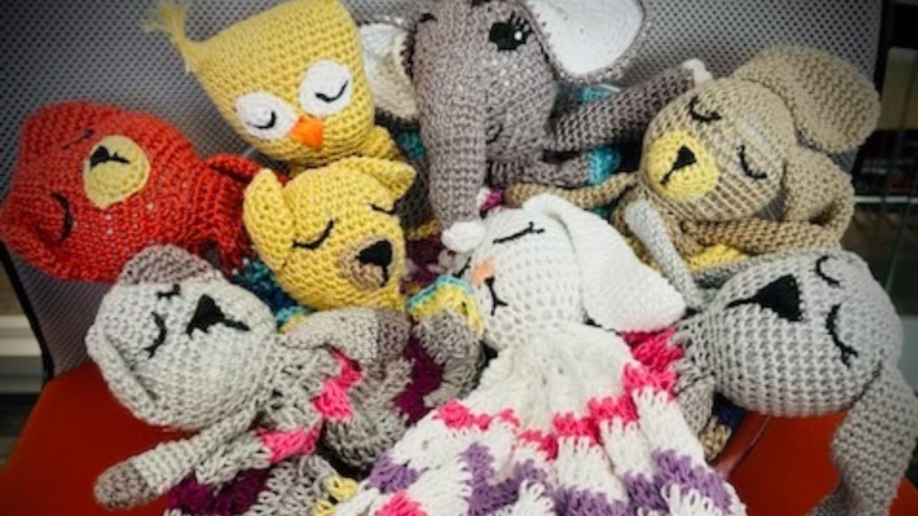 Crocheted animals in basket.