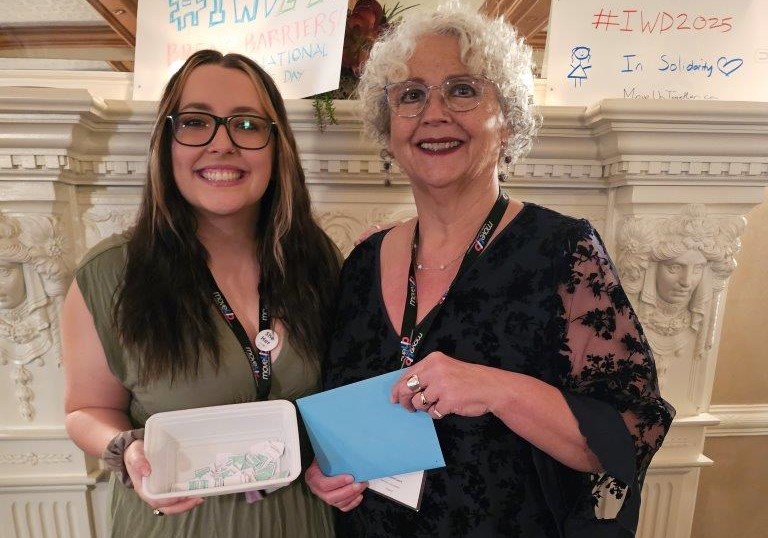 Alycia Guile and Kelly Cammack holding up raffle tickets for a prize draw