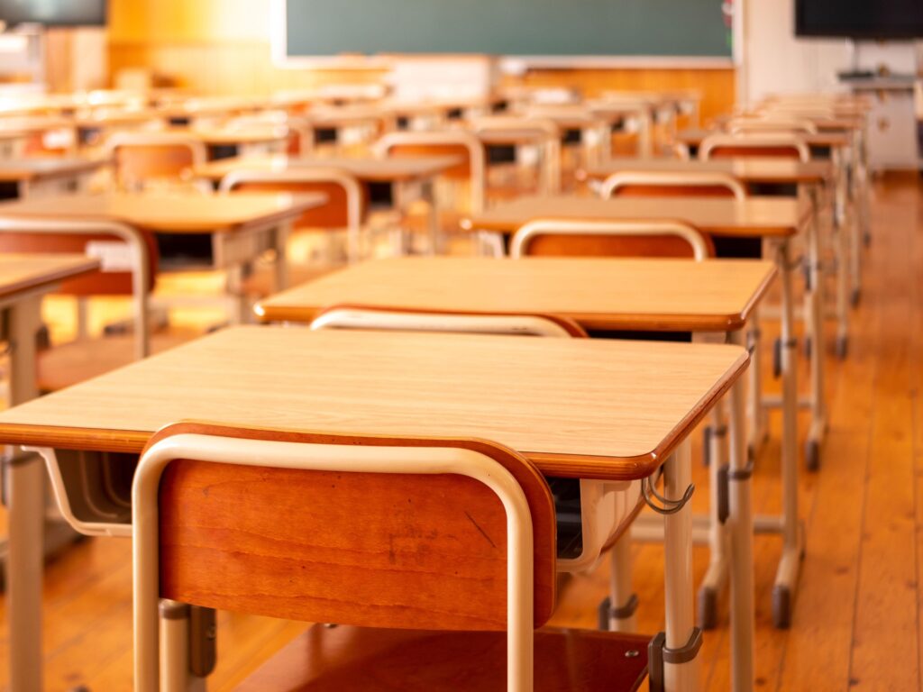 rows of desks in an empty classroom