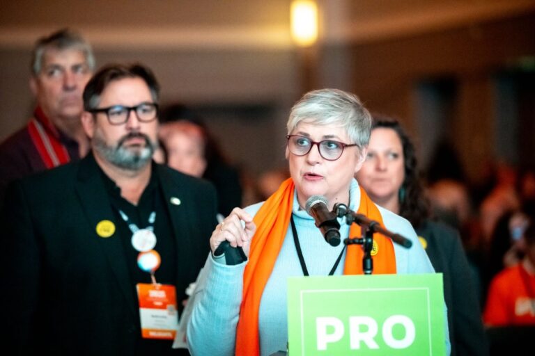 Annette Toth speaking at a microphone at the BC NDP Convention