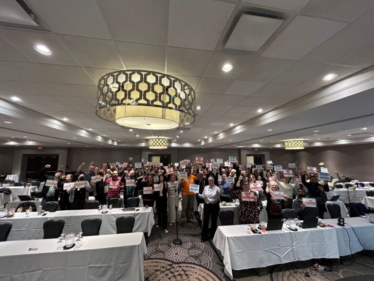 executive councillors holding placards