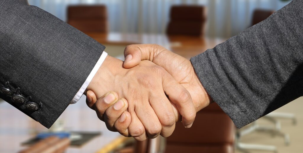 Handshake with boardroom background